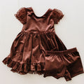 Brown velvet dress with matching bloomers on a white background