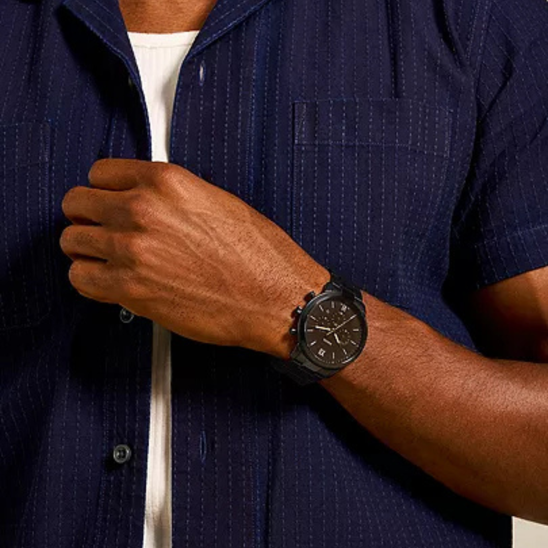 Person wearing a dark blue shirt with a watch on their wrist