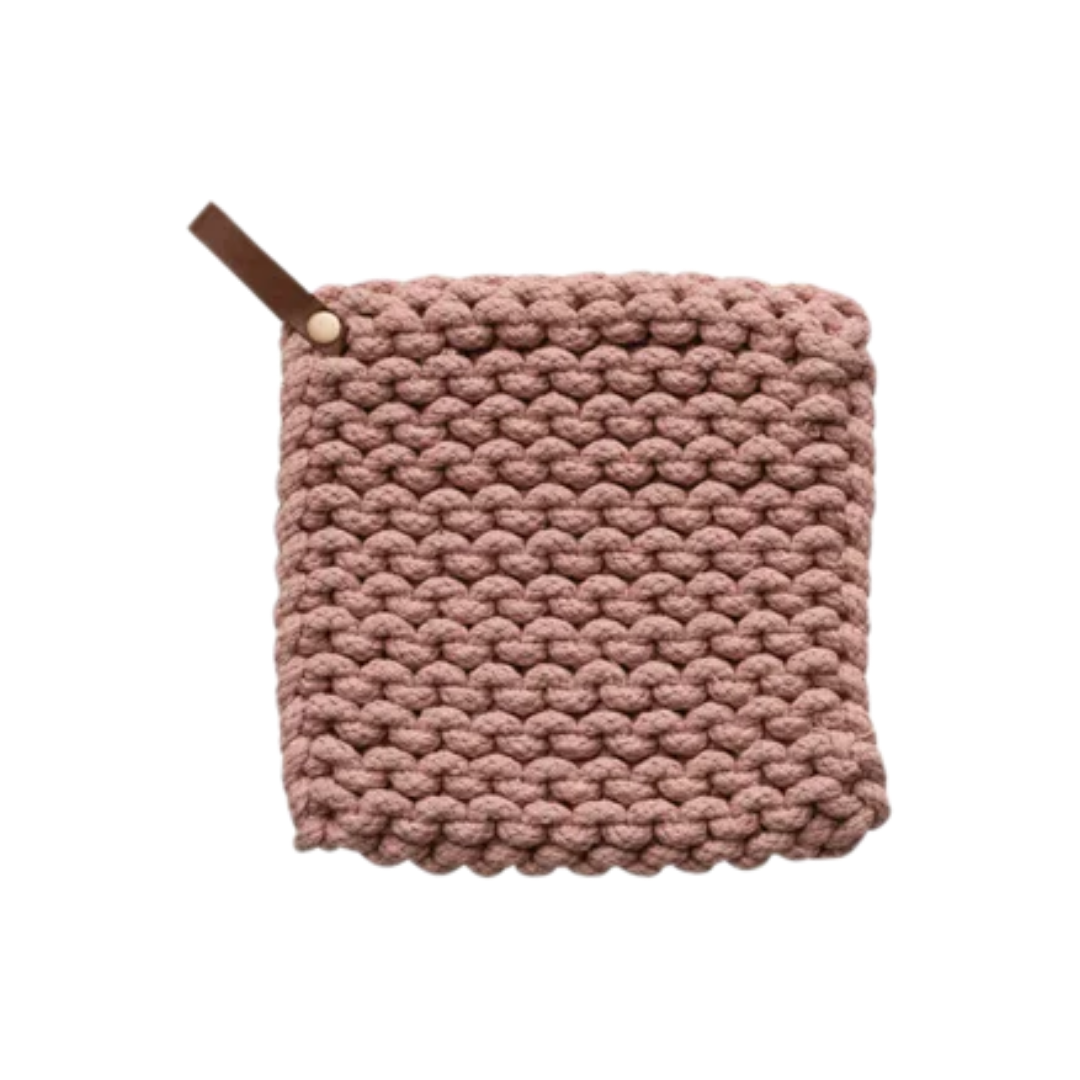 Knitted pink potholder with a brown leather strap on a white background