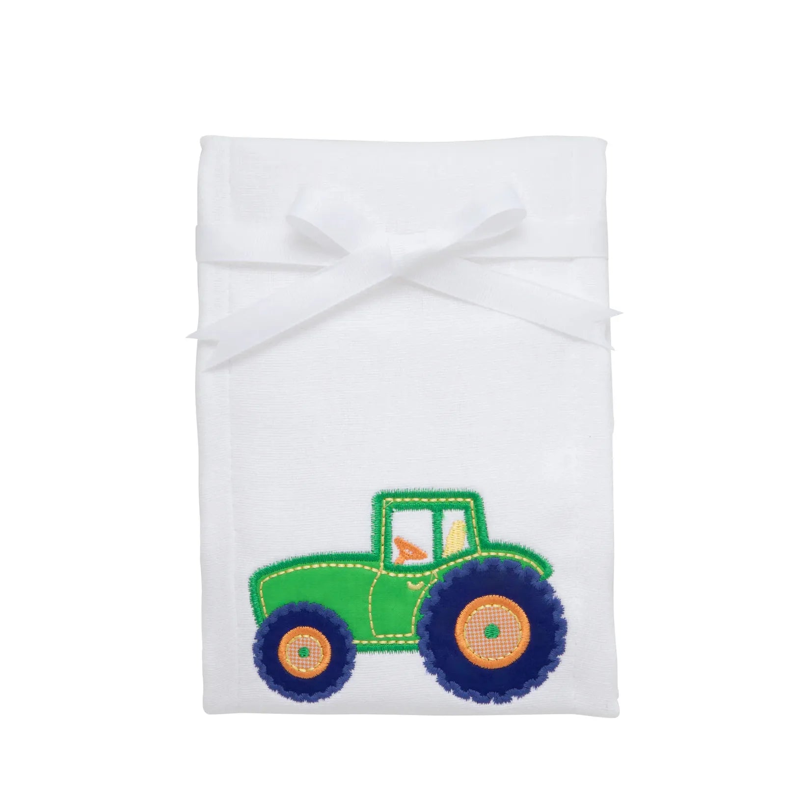 White burpcloth with colorful tractor design.