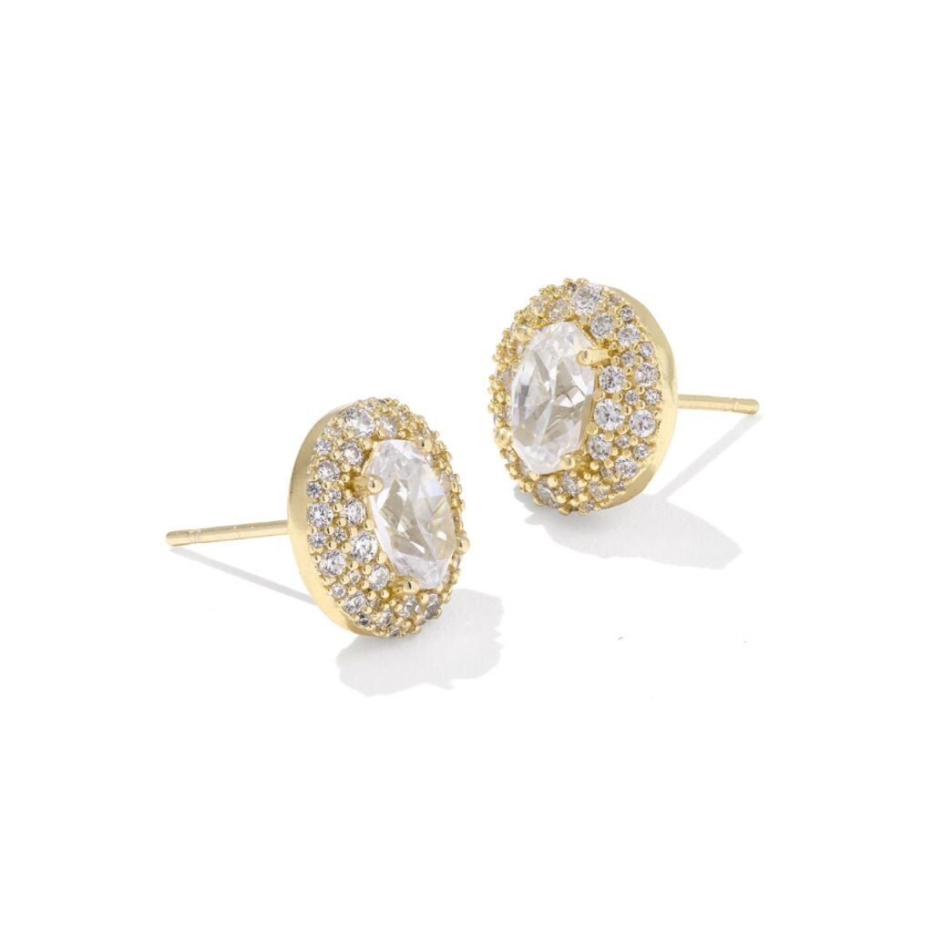 Gold earrings with clear gemstones on a white background