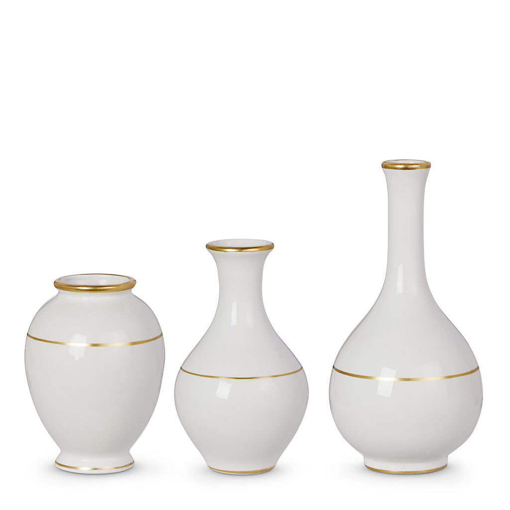 Three white vases with gold rims on a white background