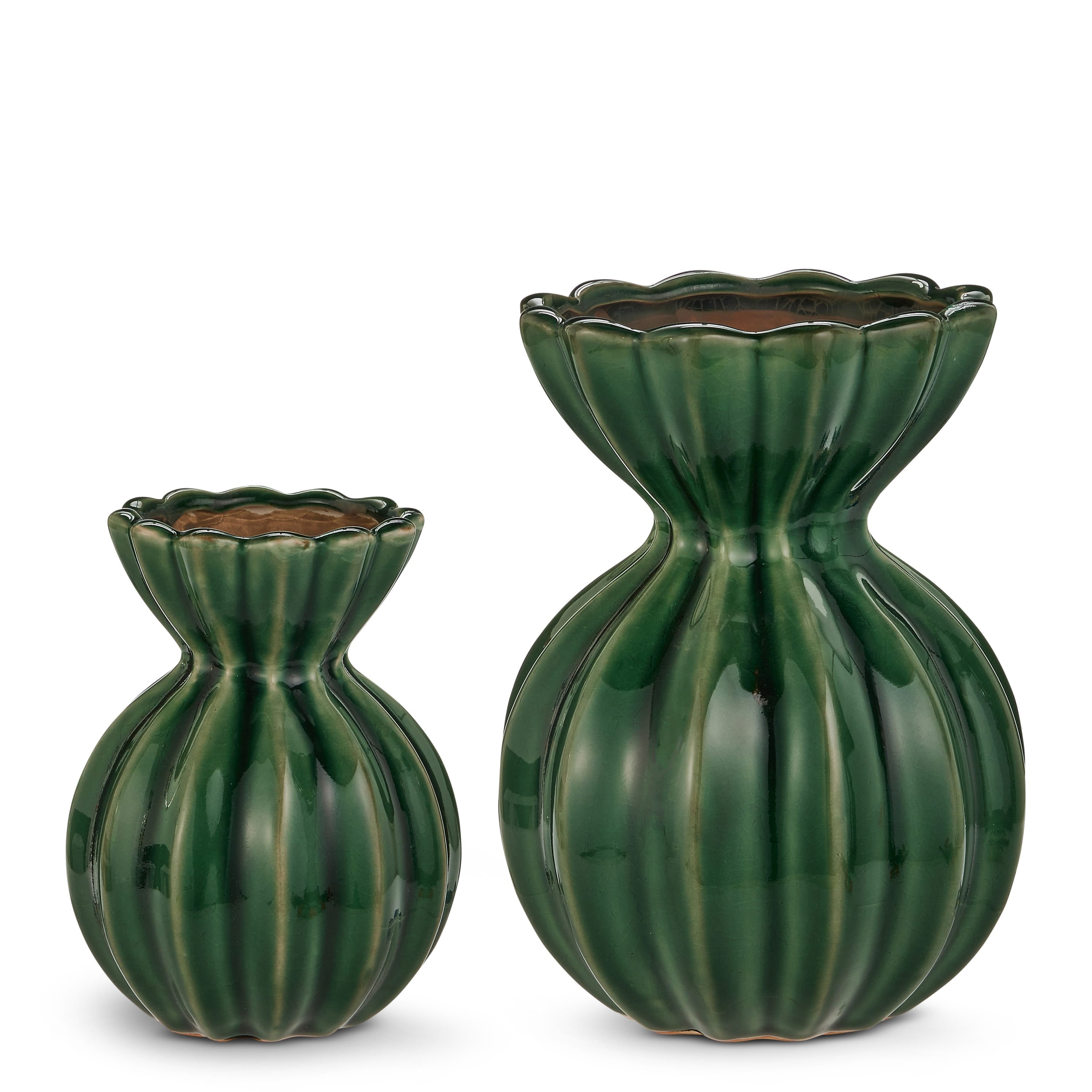 Two green ceramic vases with textured design on a white background