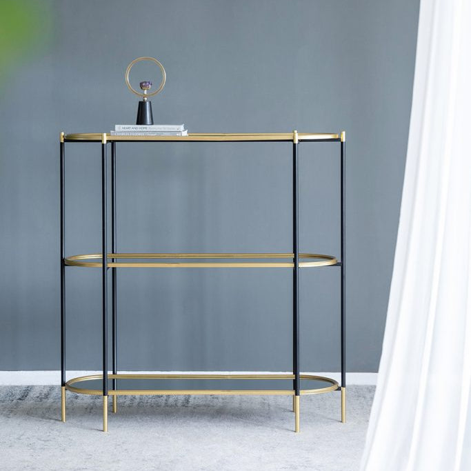 Modern side table with gold accents against a gray wall