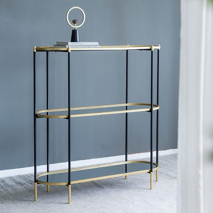Modern console table with gold accents against a gray wall