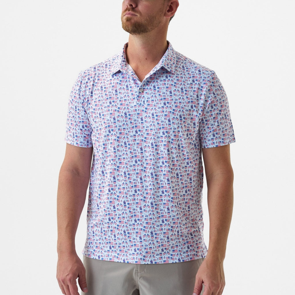 Man wearing a patterned short-sleeve shirt on a plain background
