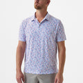 Man wearing a patterned short-sleeve shirt on a plain background