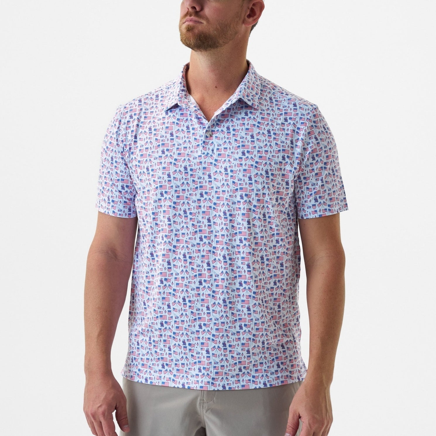 Man wearing a patterned short-sleeve shirt on a plain background