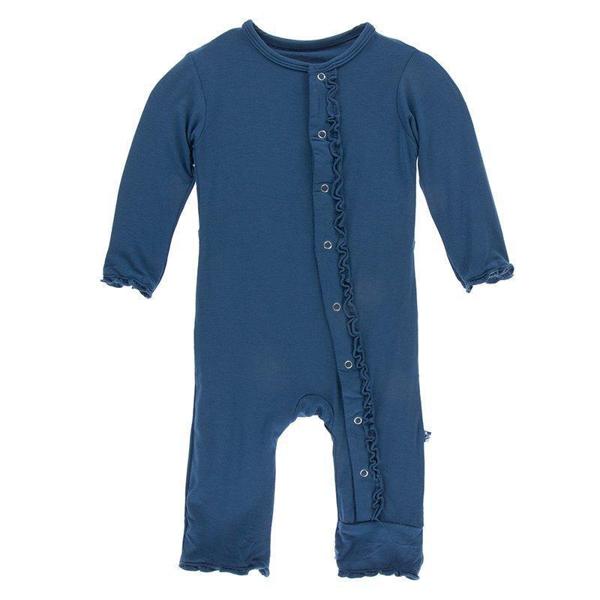 Blue baby romper with ruffled details on a white background