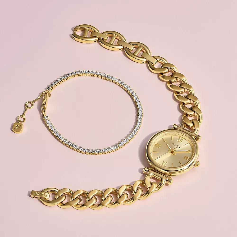 Gold chain bracelet and watch by Fossil on a pink background