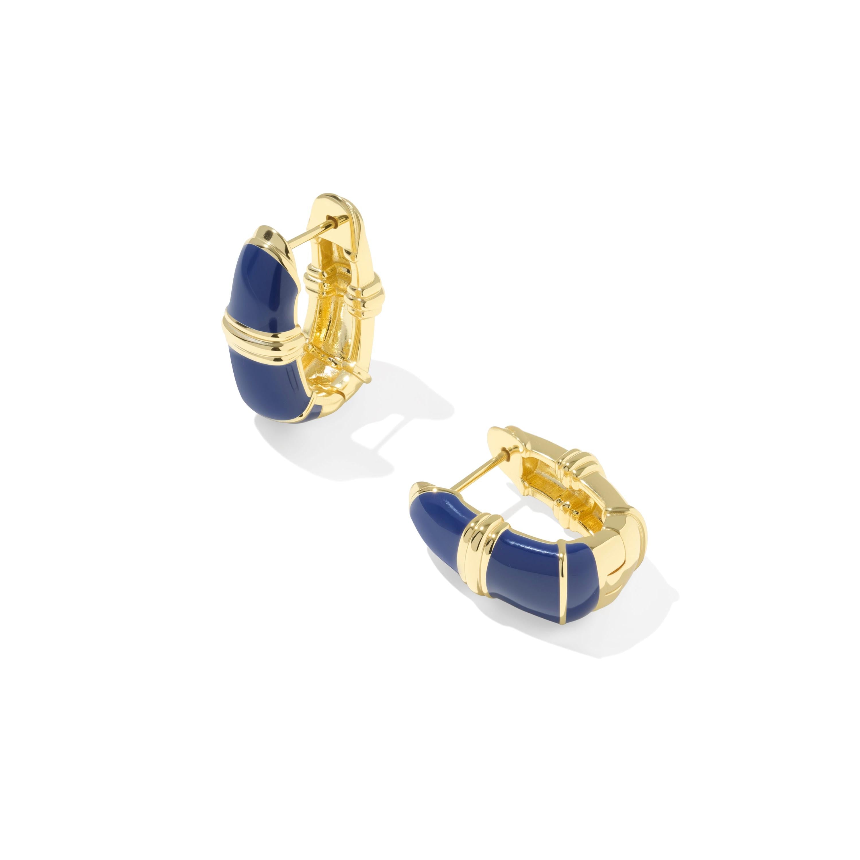 A pair of gold Kendra Scott Courtney earrings with blue enamel inlay.