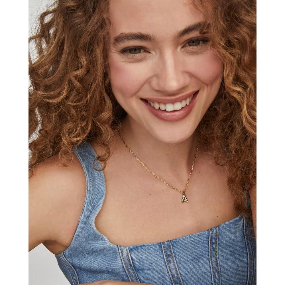 Woman wearing a Kendra Scott Crystal Letter Pendant Necklace against a neutral background