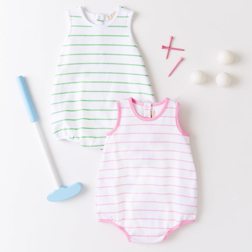 Two striped baby rompers on a white background with a blue toy and pink cross.