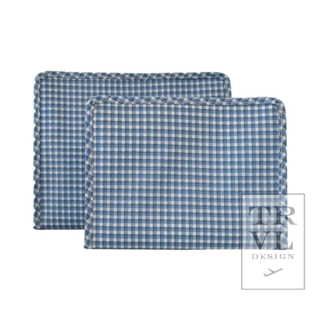 Two blue and white checkered pouches with the TRVL design logo on the bottom right.