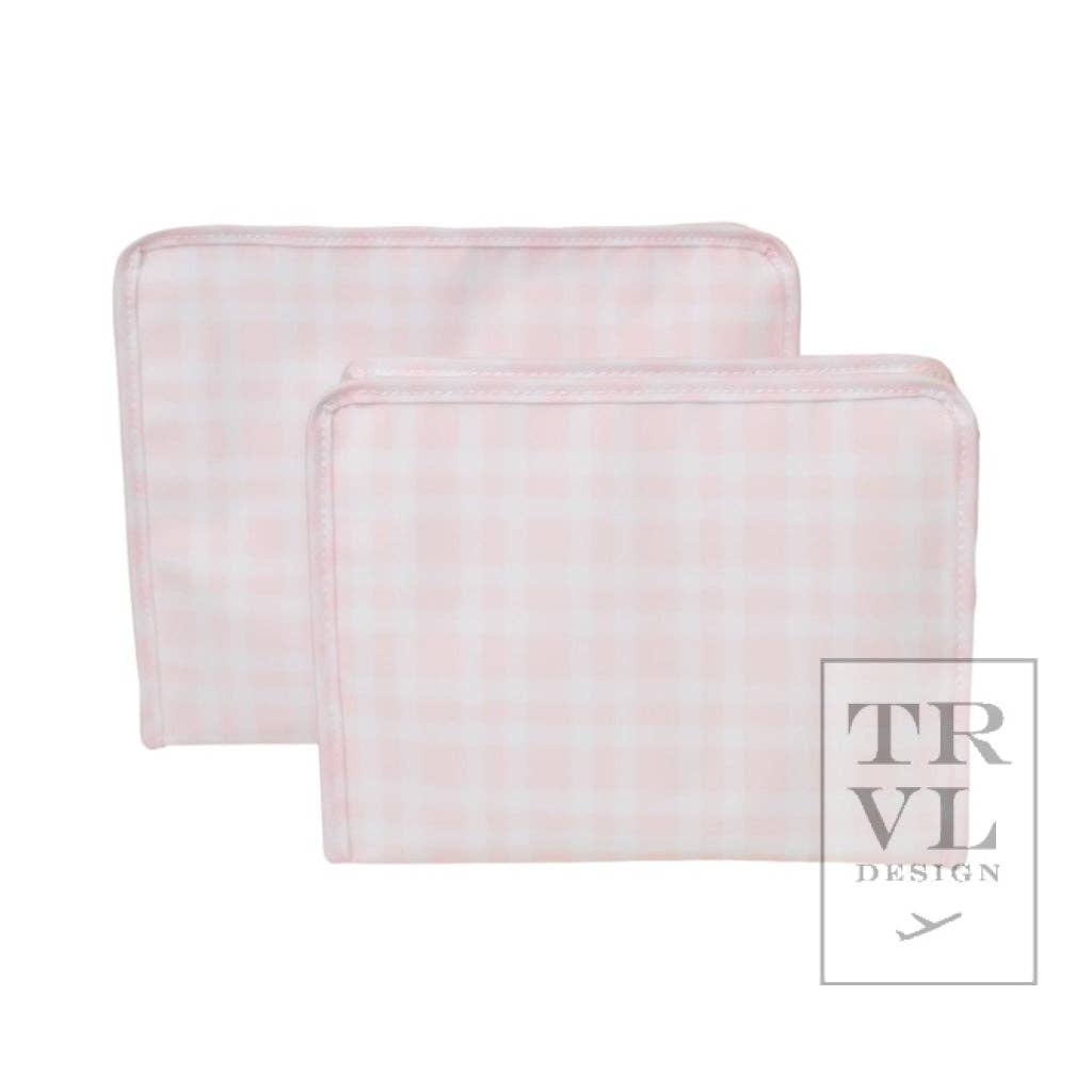 Two pink and white checkered pouches with the TRVL design logo on the bottom right.