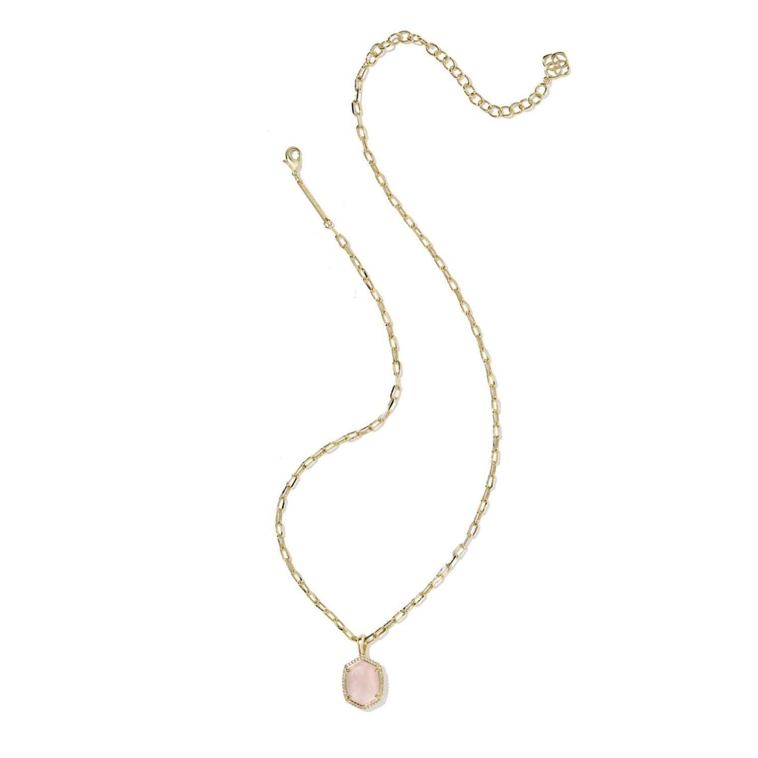 Gold necklace with a pink pendant on a white background