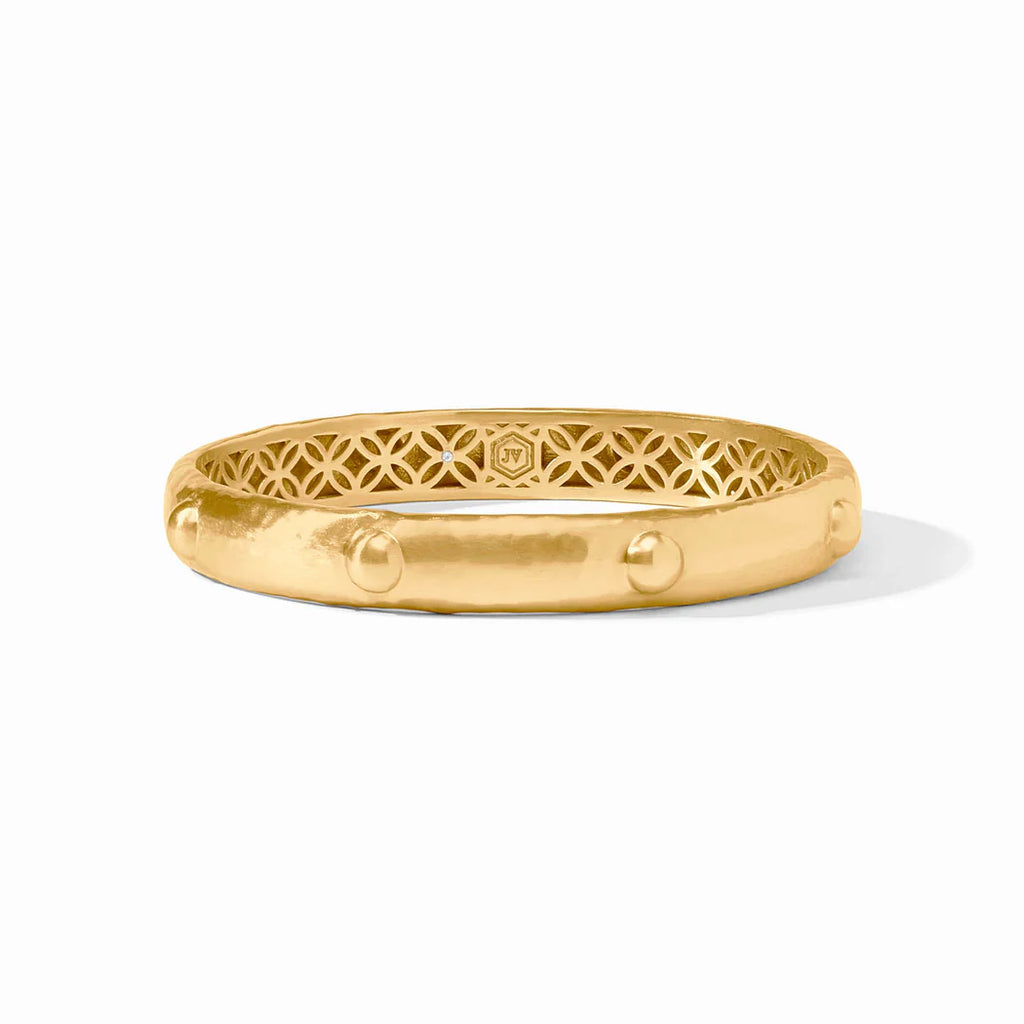 Gold bracelet with intricate design on a white background