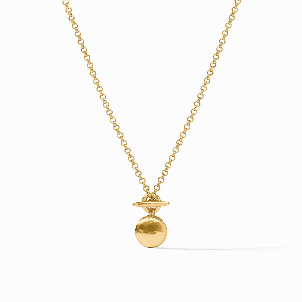 Gold necklace with a round pendant on a white background