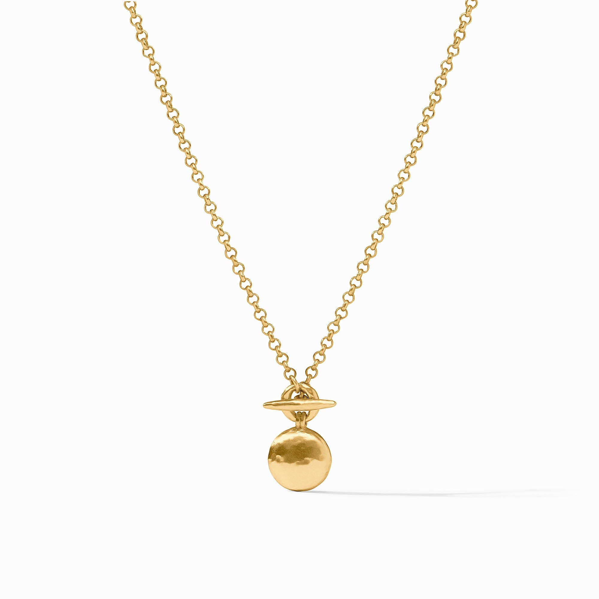 Gold necklace with a round pendant on a white background