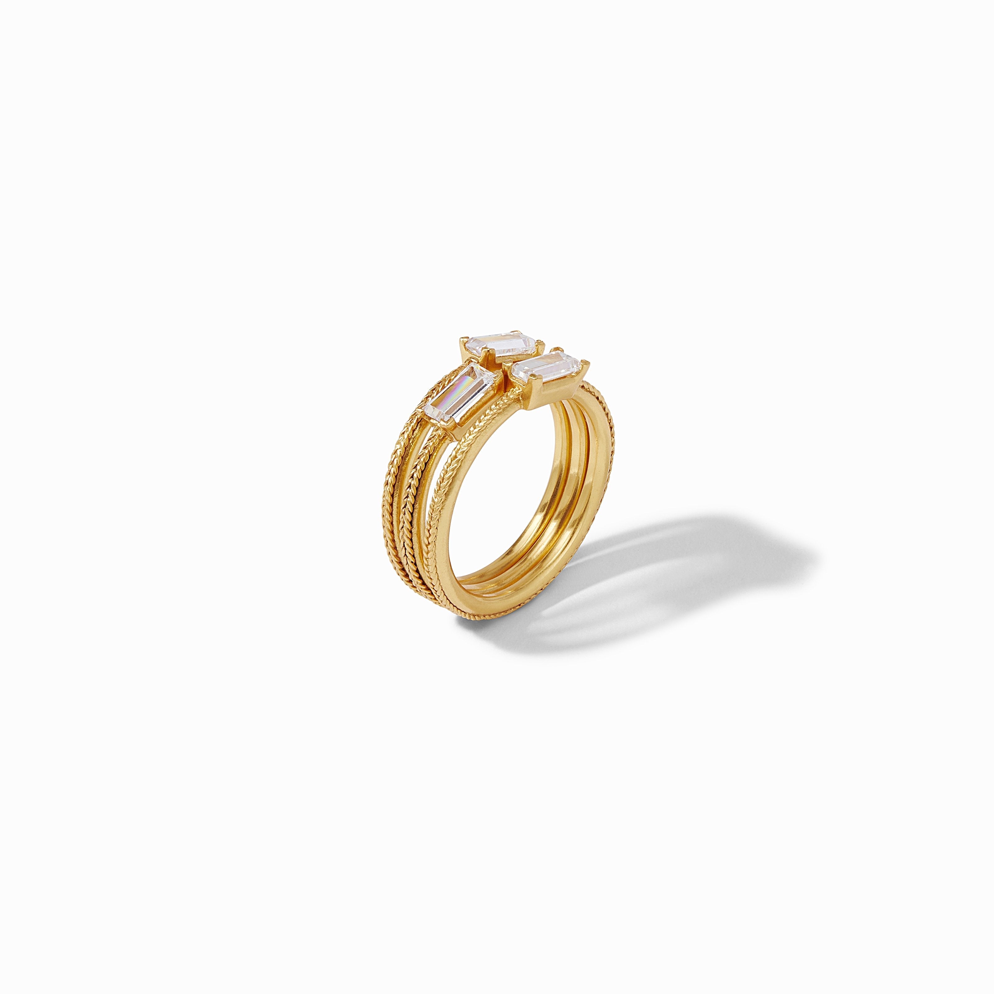 Gold ring with embedded stones on a white background