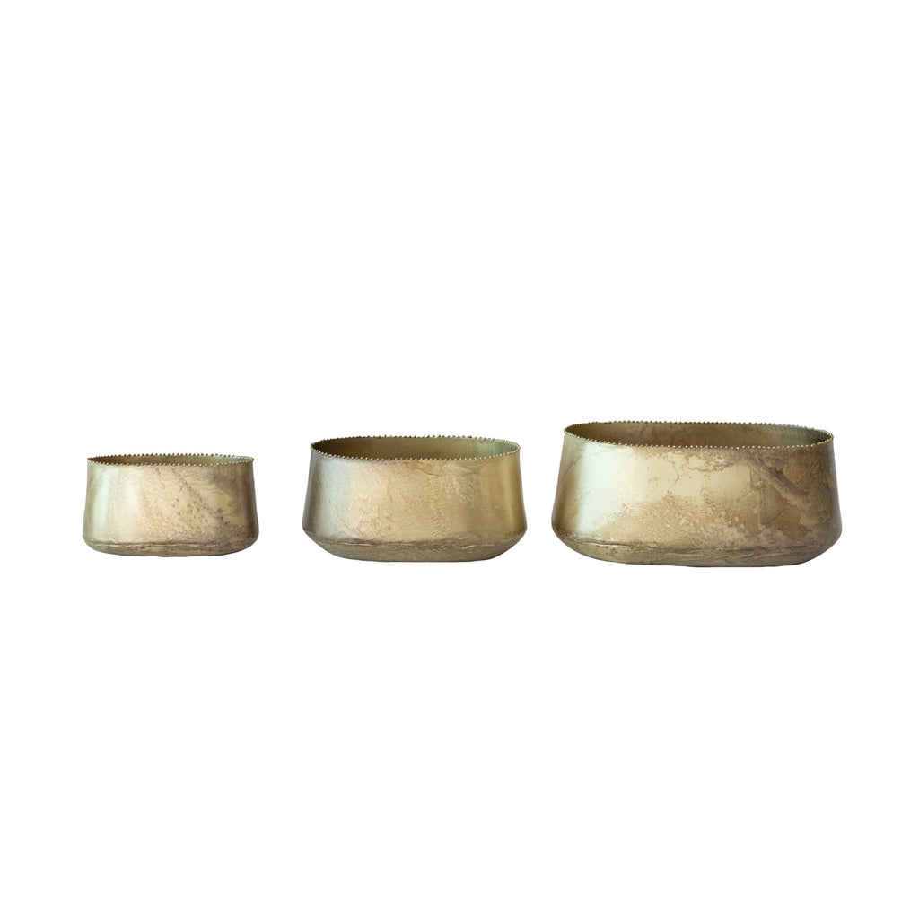 Three metallic bowls of varying sizes on a white background