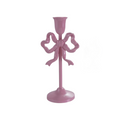 Pink candle holder with bow design on a white background