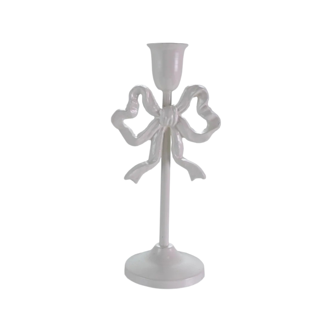 White candle holder with bow design on a white background