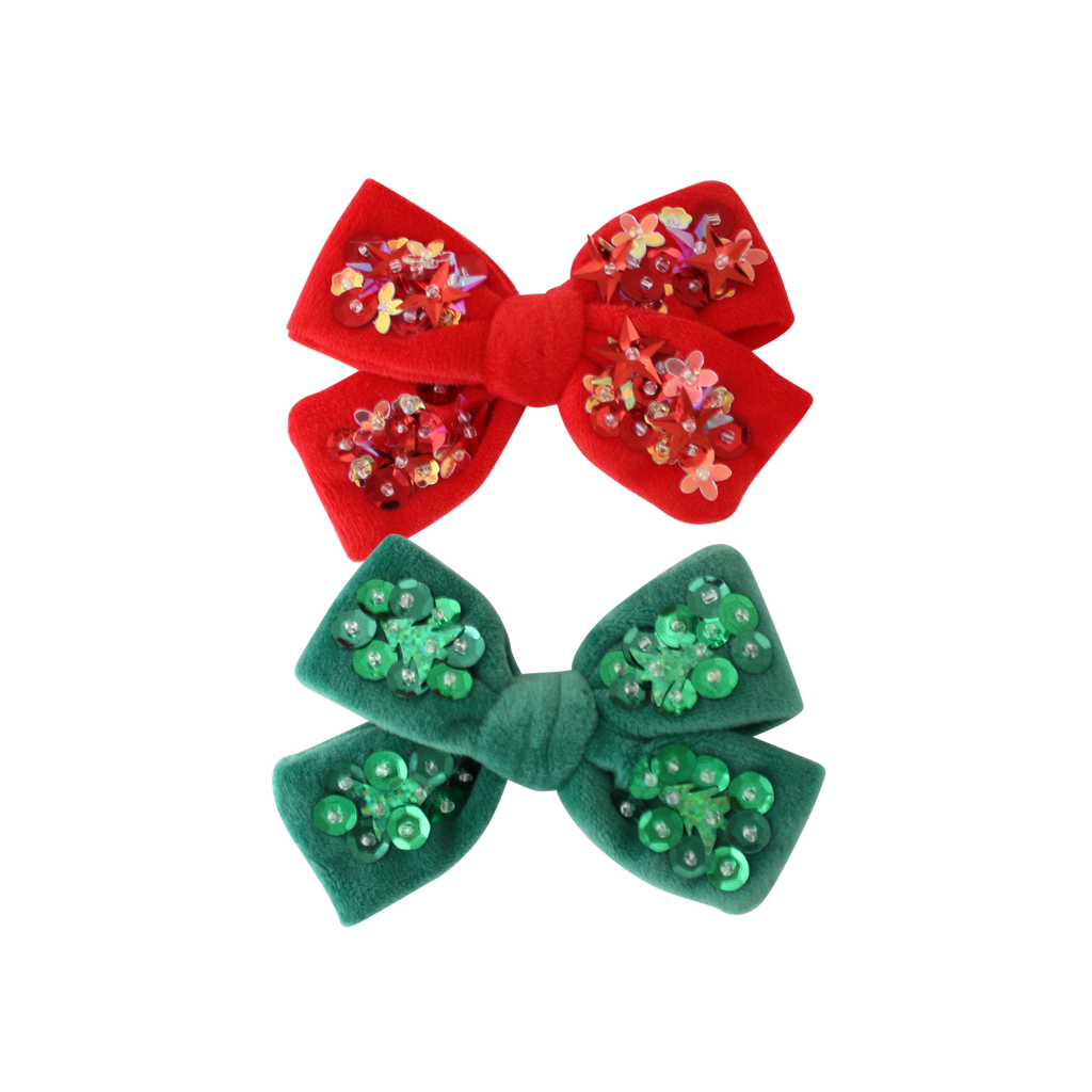 Red and green hair bows with sequin details on a white background