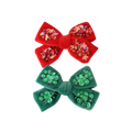 Red and green hair bows with sequin details on a white background